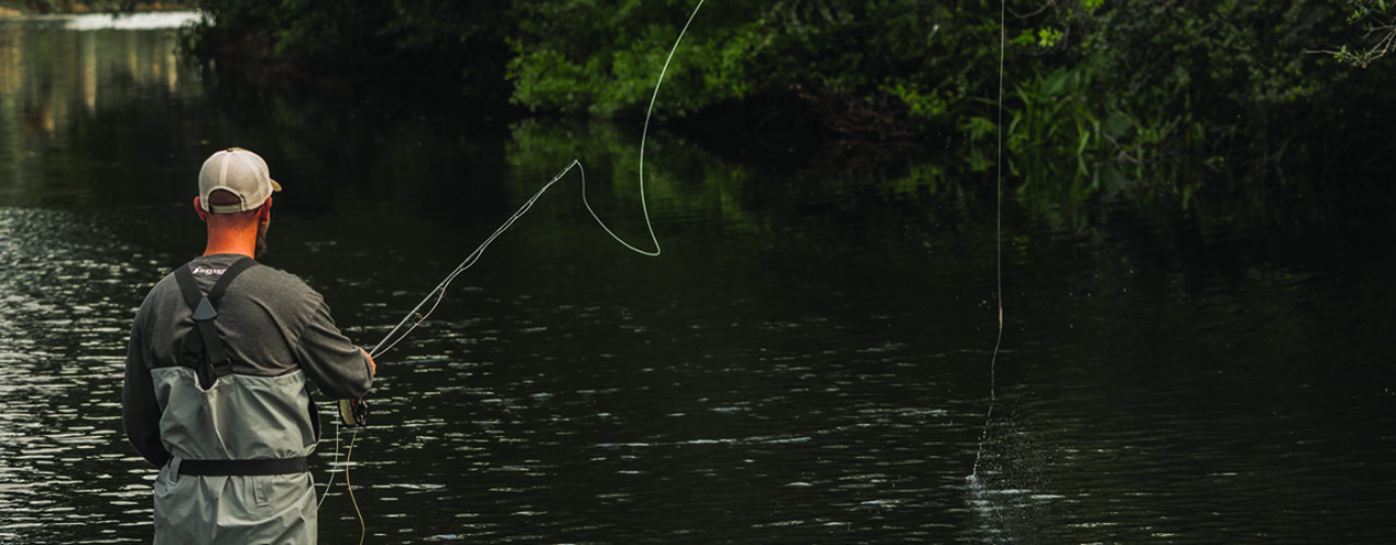 Man fishing in a river.