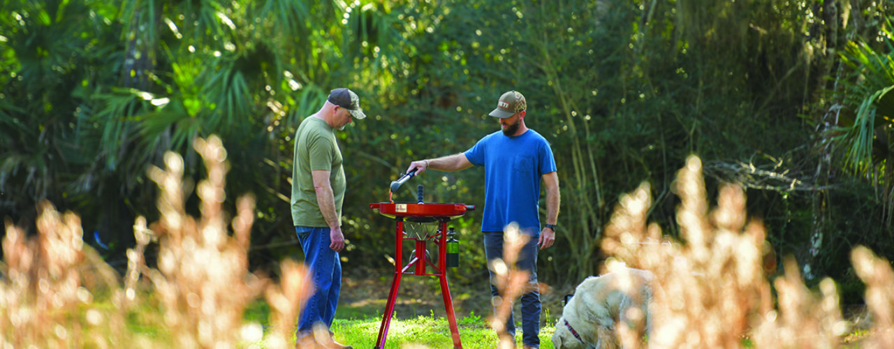 Two men cooking on a Firedisc.