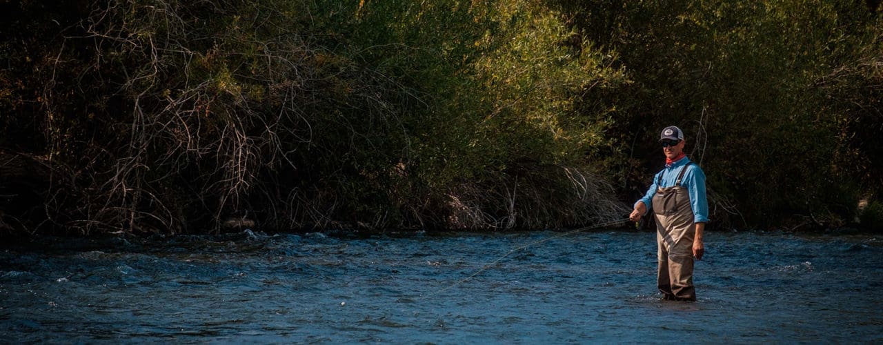 Man fishing in river.