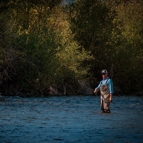 Man fishing in river.