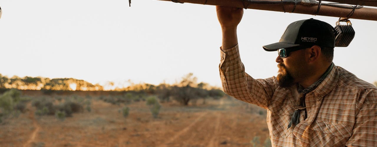 Man looking out at empty land.