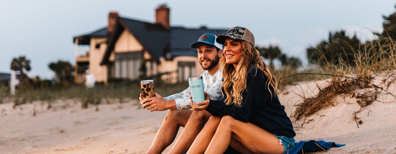 Two people sitting on the beach