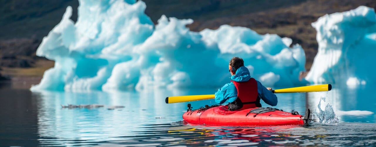 man kayaking in Greenland