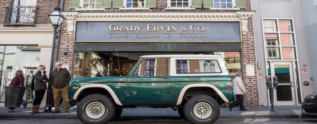 Bronco in front of store in city