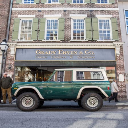 Bronco in front of store in city