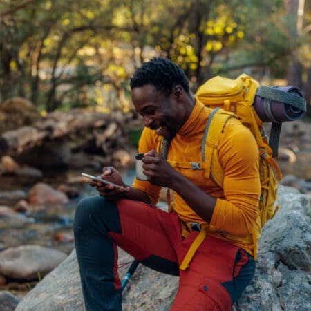 guy on hike looking at phone
